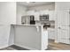 Modern kitchen features white cabinets, stainless steel appliances, and a breakfast bar at 232 Buchanan Cir, Goose Creek, SC 29445