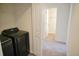A glimpse of the laundry area, showing a dark washer/dryer set, in an alcove just off a hallway at 232 Buchanan Cir, Goose Creek, SC 29445