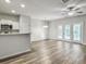 Open concept living room with kitchen, dining area, and french doors to the patio at 232 Buchanan Cir, Goose Creek, SC 29445