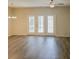Cozy living room with hardwood floors, ceiling fan, and French doors to the backyard at 232 Buchanan Cir, Goose Creek, SC 29445