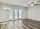 Bright living room features wood flooring, ceiling fan, and french doors at 232 Buchanan Cir, Goose Creek, SC 29445