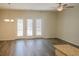 Bright living room with hardwood floors, ceiling fan, and French doors overlooking the backyard at 232 Buchanan Cir, Goose Creek, SC 29445