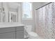 Well-lit bathroom with a white toilet, gray vanity, and polka-dotted shower curtain at 2461 Lieutenant Dozier Dr, Johns Island, SC 29455