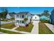 Two-story home featuring double porches, palm trees, driveway, and a detached garage at 2461 Lieutenant Dozier Dr, Johns Island, SC 29455