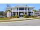 Stunning raised community center with white railings, metal roof, landscaping, and palm trees at 2461 Lieutenant Dozier Dr, Johns Island, SC 29455