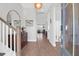 Bright foyer with wood floors, staircase, large mirror, and an open view to the living spaces at 2461 Lieutenant Dozier Dr, Johns Island, SC 29455