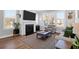 Cozy living room featuring a fireplace, large windows, and neutral-toned furniture at 2461 Lieutenant Dozier Dr, Johns Island, SC 29455