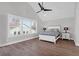 Bright main bedroom features a ceiling fan, wood floors, and bright windows at 2461 Lieutenant Dozier Dr, Johns Island, SC 29455