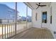 Covered porch with wooden floors, white railings, ceiling fan, and views of other homes at 2461 Lieutenant Dozier Dr, Johns Island, SC 29455