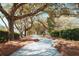 Scenic walking path lined with mature trees creating a beautiful canopy and serene atmosphere at 2461 Lieutenant Dozier Dr, Johns Island, SC 29455