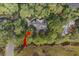 An aerial view of a wooded luxury home surrounded by lush foliage and a winding creek at 2515 Cat Tail Pond Rd, Seabrook Island, SC 29455