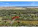 Aerial shot of a wooded community near a golf course and wetlands under a partly cloudy sky at 2515 Cat Tail Pond Rd, Seabrook Island, SC 29455
