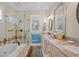 Elegant bathroom featuring a soaking tub, glass shower, and double vanity with granite countertops and decorative mirrors at 2515 Cat Tail Pond Rd, Seabrook Island, SC 29455