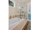 Bathroom showcasing a luxurious soaking tub, a frameless shower, and diamond-patterned tile accents at 2515 Cat Tail Pond Rd, Seabrook Island, SC 29455