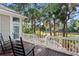 Relax on the deck with rocking chairs and views of the tree-lined landscape at 2515 Cat Tail Pond Rd, Seabrook Island, SC 29455