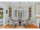 A bright dining area includes a large table, built-in bookshelves, and a window with wooded view at 2515 Cat Tail Pond Rd, Seabrook Island, SC 29455