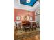 Formal dining room features neutral toned rug, matching curtains and a wooden dining table set for six at 2515 Cat Tail Pond Rd, Seabrook Island, SC 29455