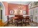 Formal dining room features neutral toned rug, matching curtains and a wooden dining table set for six at 2515 Cat Tail Pond Rd, Seabrook Island, SC 29455