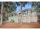 Rear exterior view of home featuring a spacious deck and well-maintained landscaping at 2515 Cat Tail Pond Rd, Seabrook Island, SC 29455
