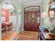 Inviting foyer features a hardwood floor, beautiful rugs, and a stunning wooden front door with glass panel inserts at 2515 Cat Tail Pond Rd, Seabrook Island, SC 29455