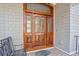 Close up of a beautiful wood door, with brick stairs and a cozy bench at 2515 Cat Tail Pond Rd, Seabrook Island, SC 29455