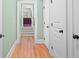 Bright hallway featuring hardwood floors, neutral paint, and access to another room at 2515 Cat Tail Pond Rd, Seabrook Island, SC 29455