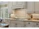 A well-equipped kitchen features granite counters and a stainless cooktop, perfect for culinary endeavors at 2515 Cat Tail Pond Rd, Seabrook Island, SC 29455