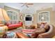 Comfortable living room featuring plush seating, natural light, and a ceiling fan at 2515 Cat Tail Pond Rd, Seabrook Island, SC 29455