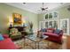 Inviting living room with large windows, ceiling fans, comfortable seating, and a decorative area rug at 2515 Cat Tail Pond Rd, Seabrook Island, SC 29455