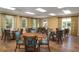 Comfortable meeting room filled with wood tables and chairs with natural light from large windows, great for gatherings at 2515 Cat Tail Pond Rd, Seabrook Island, SC 29455