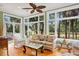 A sunroom offers bright lighting, wicker furniture, and large windows showcasing the outdoor landscape at 2515 Cat Tail Pond Rd, Seabrook Island, SC 29455