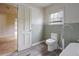 A bathroom featuring toilet, small window, and doorway leading to another room at 2604 Highway 78, Dorchester, SC 29437
