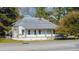 Charming single-story home featuring a covered front porch and a brick chimney, set on a tree-lined street at 2604 Highway 78, Dorchester, SC 29437