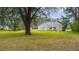 Landscaped front yard showcasing mature trees and a vintage house with a classic architectural design at 2604 Highway 78, Dorchester, SC 29437