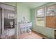 A utility sink area with green paneled walls, a doorway to another room, and a small window at 2604 Highway 78, Dorchester, SC 29437