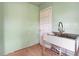 A utility sink area with green paneled walls, a door, and a small window at 2604 Highway 78, Dorchester, SC 29437