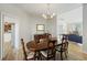 Open dining room with wood table, chandelier, and open access to the living room at 2606 Marsh Creek Dr, Charleston, SC 29414