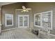 Covered porch with wooden floors, ceiling fan, rocking chairs and great natural light at 2606 Marsh Creek Dr, Charleston, SC 29414