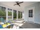 Screened-in porch with chairs and a view of the wooded backyard at 2620 Private Lefler Dr, Johns Island, SC 29455