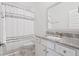Well-lit bathroom with granite countertop vanity, white cabinets, and shower featuring a decorative curtain at 2901 Eddy Dr, Mount Pleasant, SC 29466
