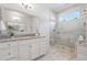 Elegant bathroom featuring a glass-enclosed shower, white cabinets, and a neutral color palette at 2901 Eddy Dr, Mount Pleasant, SC 29466