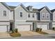 Charming townhome featuring colorful siding, a one-car garage, and manicured landscaping at 2901 Eddy Dr, Mount Pleasant, SC 29466