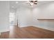 Bright living room with wood floors, white walls, ceiling fan, and access to bedroom and utility room at 2901 Eddy Dr, Mount Pleasant, SC 29466
