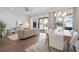Bright living room with hardwood floors, dining area, neutral decor, and sliding glass doors to outdoor area at 2901 Eddy Dr, Mount Pleasant, SC 29466