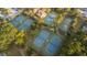 Aerial view of multiple well-maintained tennis courts surrounded by lush greenery and trees at 2901 Eddy Dr, Mount Pleasant, SC 29466