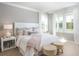 Comfortable bedroom with large windows, soft lighting, and stylish decor at 295 Citrus Dr, Summerville, SC 29486