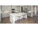 Modern kitchen with gray cabinets, marble countertops, stainless steel appliances, and a spacious island at 295 Citrus Dr, Summerville, SC 29486