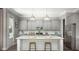 Modern kitchen with gray cabinets, marble countertops, stainless steel appliances, and a spacious island at 295 Citrus Dr, Summerville, SC 29486