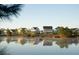 Scenic view of a pond with residents canoeing, and picturesque homes in the background at 295 Citrus Dr, Summerville, SC 29486