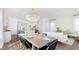 Open-concept dining room with a large table and a modern chandelier at 297 Citrus Dr, Summerville, SC 29486
